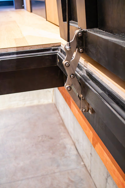 Floor Door Hinge and Gas Strut installed in an open door.