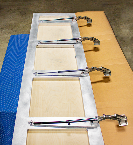 Floor Door Hinge and Gas Strut installed on an Aluminum Door Frame designed and manufactured by Brandner Design. Make a consultation for a floor door frame today sending an email at sales@brandnerdesign.com